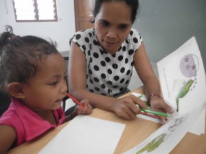 Parent and child learning with pen and book