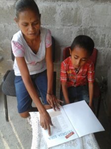 Photo of parent with child in Timor Leste reading
