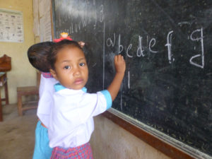 Children standing at blackboard in Timor-Leste