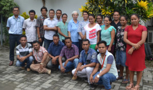 Group photo of staff at MMI Timor-Leste in front of building