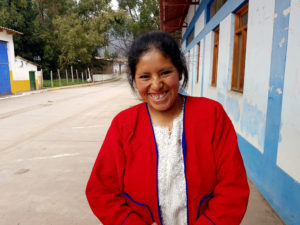 Peruvian woman in street smiling at camera