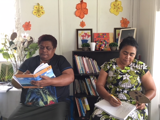 Two Fijian women signing partnerships papers with Mary MacKillop Today
