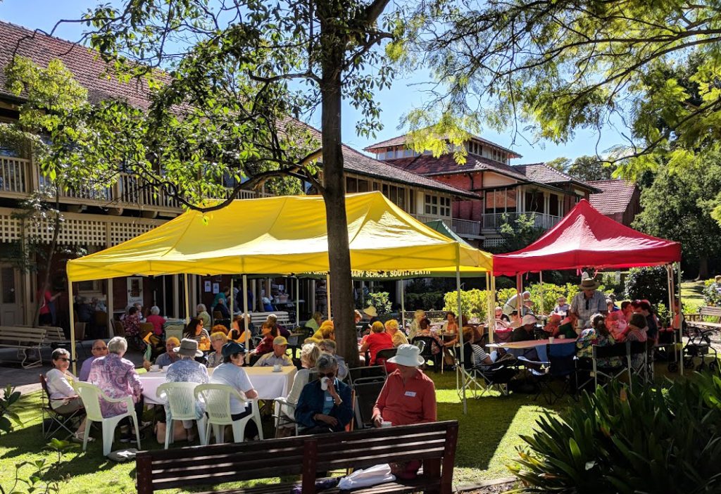 Picini Tables on grounds of St Joseph's convent in Western Australia with people seated at the tables eating breakfast