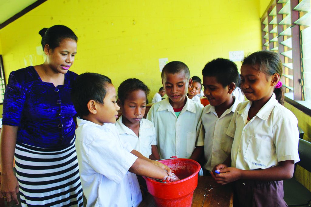Professor Clara is teaching children in her class to wash their hands