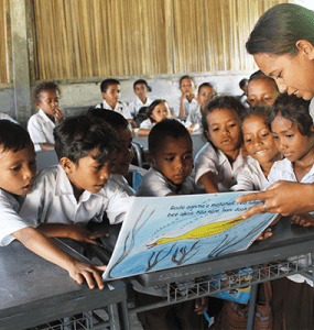 Image of teacher with students in Timor Leste