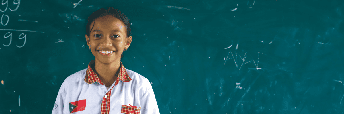 Image of child in front of blackboard
